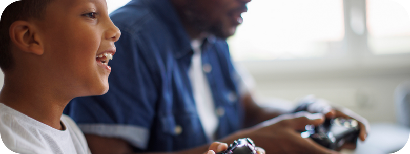 A young boy and his father engaged playing games