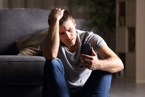 Distressed young man on phone